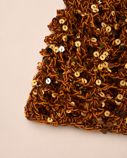 Close-up detail of The Capri Hat showing handmade crochet stitch texture and olive green metallic yarn with breathable mesh construction.