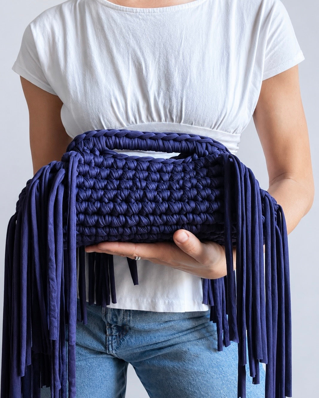 Close-up of bold crochet texture and fringe detail on Chezsue clutch bag