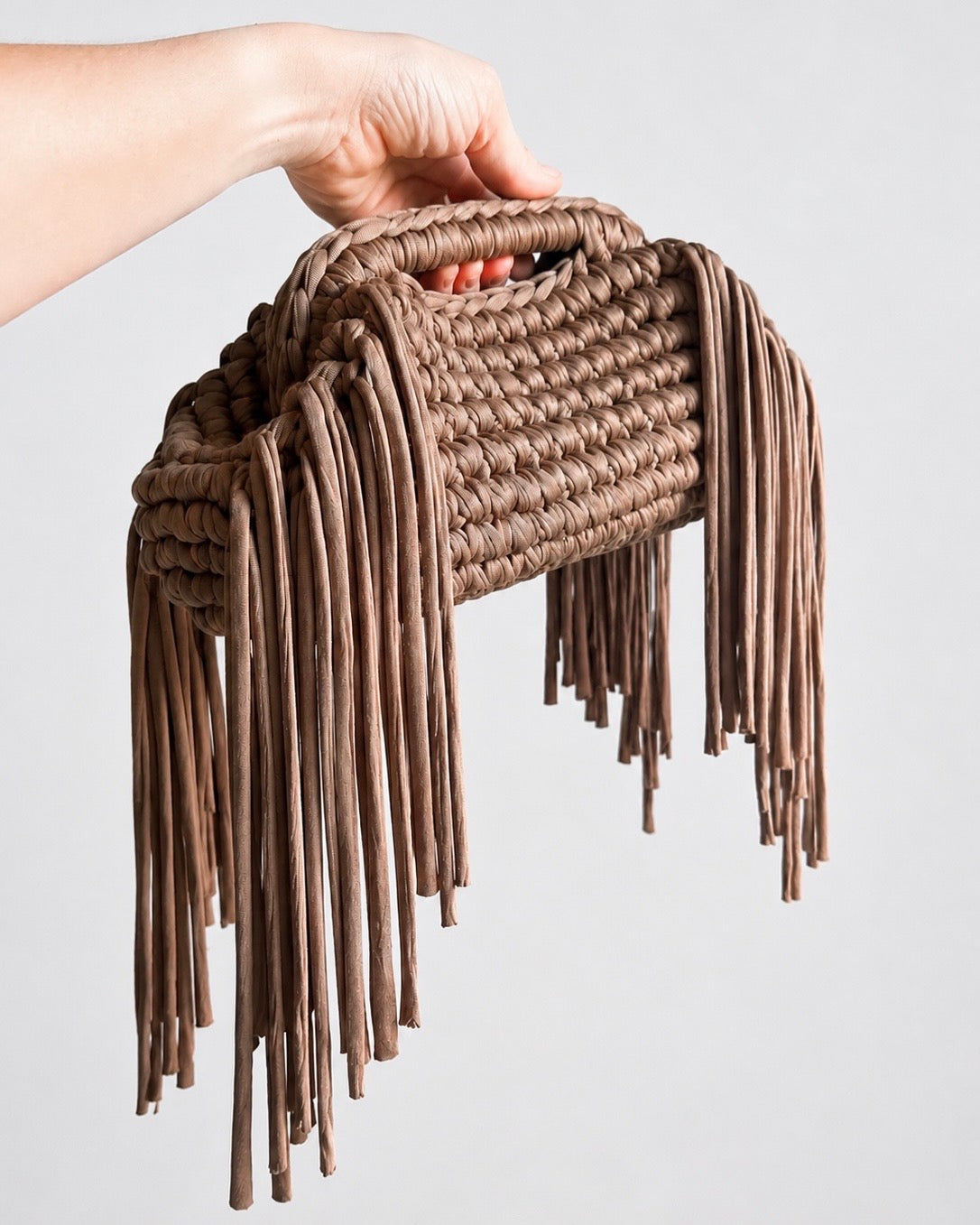 Handmade crochet clutch bag with signature side fringe detail