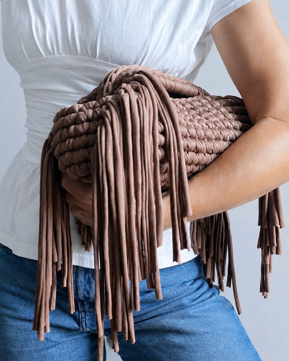 Close-up of bold crochet texture and fringe detail on Chezsue clutch bag