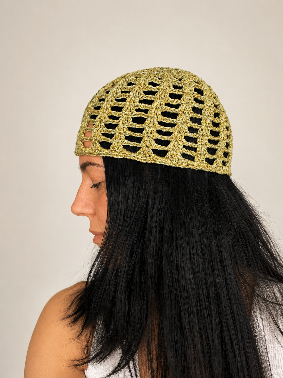 Side view of The Capri Hat, handmade crochet mesh hat in olive green metallic yarn, breathable summer accessory handcrafted in Australia.