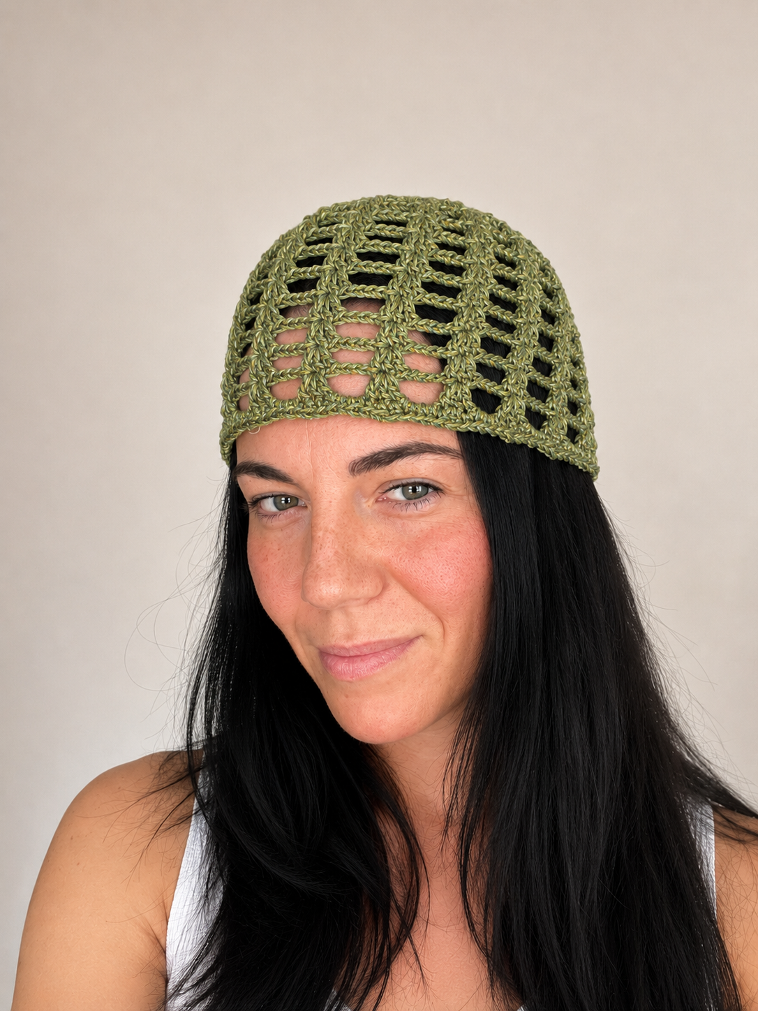 Handmade crochet mesh hat in olive green metallic yarn, front view worn by model, lightweight summer headwear handmade in Australia.
