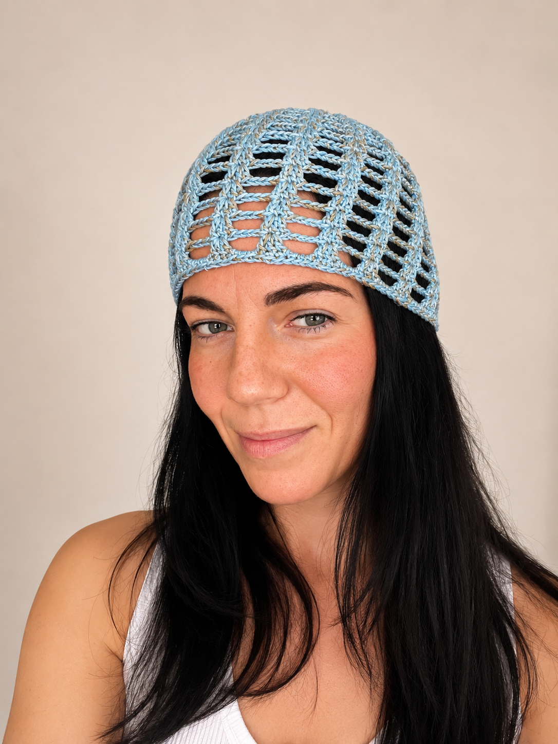 Handmade crochet mesh hat in olive green metallic yarn, front view worn by model, lightweight summer headwear handmade in Australia.